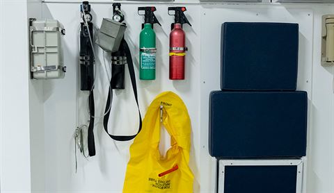 inset-From left to right: smoke hood, oxygen, BCF fire extinguisher, life jacket and torch